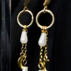 Witchy stainless steel earrings in gold. Features a moon clasp, moon and pearl pendants dangling from chains