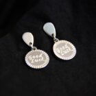 minimalist stainless steel earrings in silver with a Good luck engraved charm