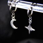 Mismatched witchy earrings featuring a star and a moon, with stainless steel clasps