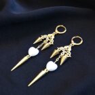 Gothic punk stainless steel earrings in gold with spikes, heart pearls charms and intricate ornements.