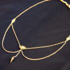 Requiem gothic punk choker necklace in gold. A necklace with small gold ornements and a spike dangling