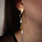 Witchy stainless steel earrings in gold. Features a moon clasp, moon and pearl pendants dangling from chains