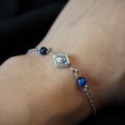 Delicate minimalist boho stainless steel bracelet in silver with an boho inspired charm and blue crystals