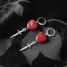 Punk silver earrings with a red heart charm and dangling daggers