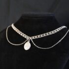 Silver choker with different layered chains and a sacred pendant
