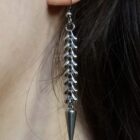 Edgy punk silver earrings, with a spinal cord and a spike